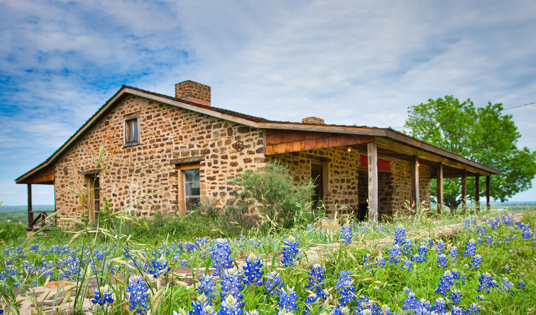 rustic building with flowers in front