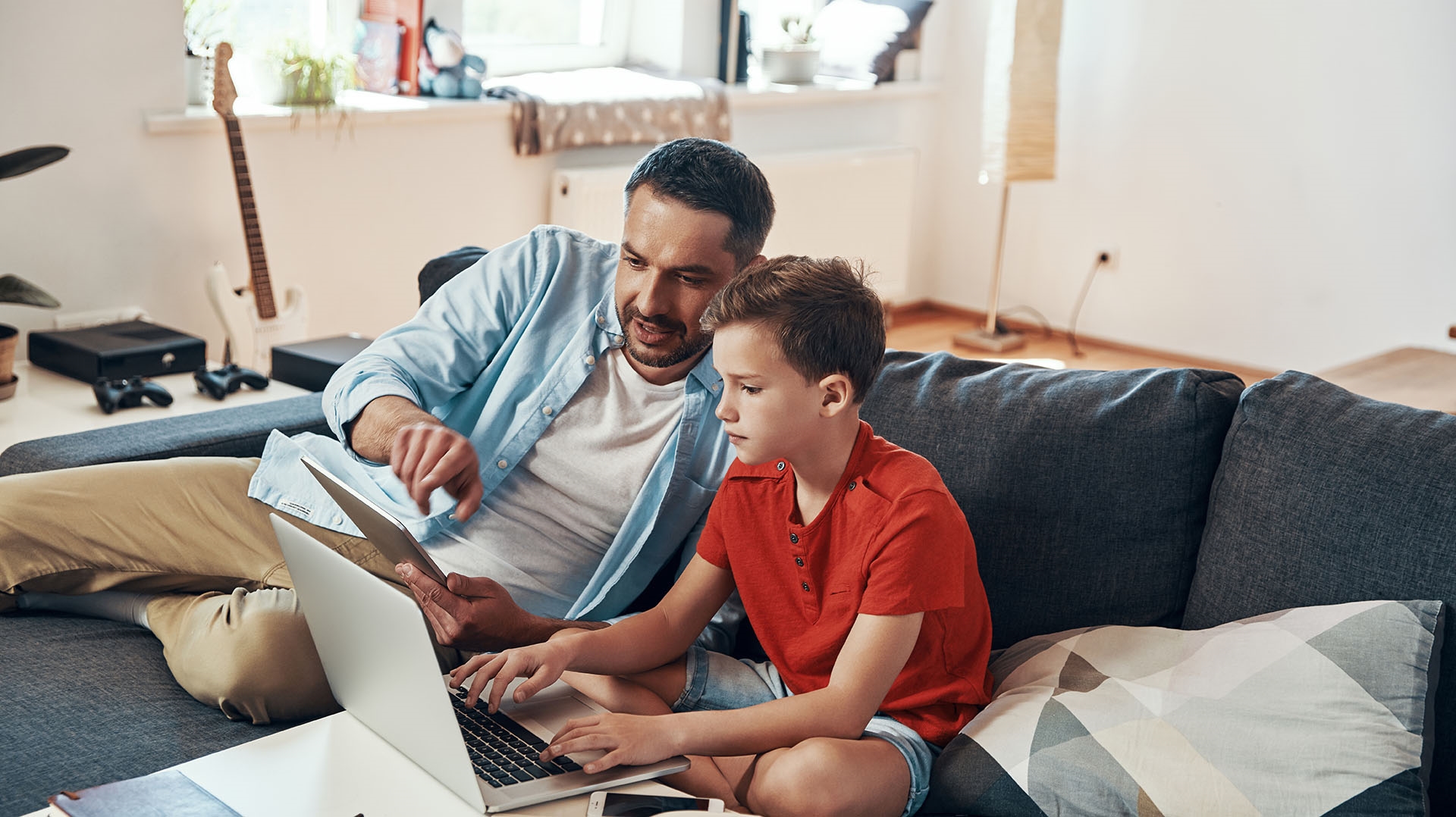 father and son working on a laptop